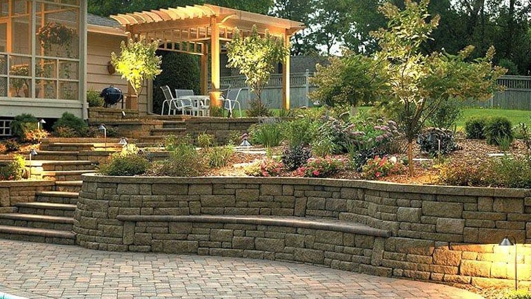 Retaining wall installation Chicago A well lit retaining wall with a gazebo on top of it.